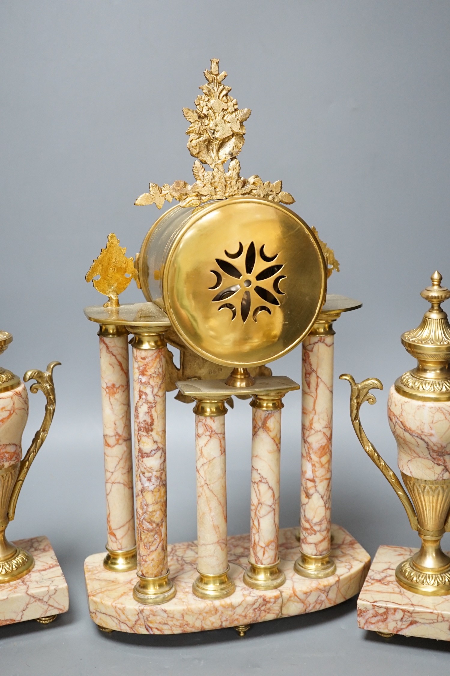 A French gilt metal and marble clock garniture, 38cm